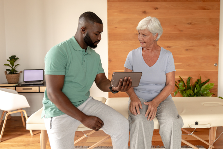 Senior woman discussing chiropractic options with specialist.