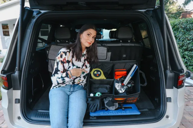A woman sitting in the back of a white van