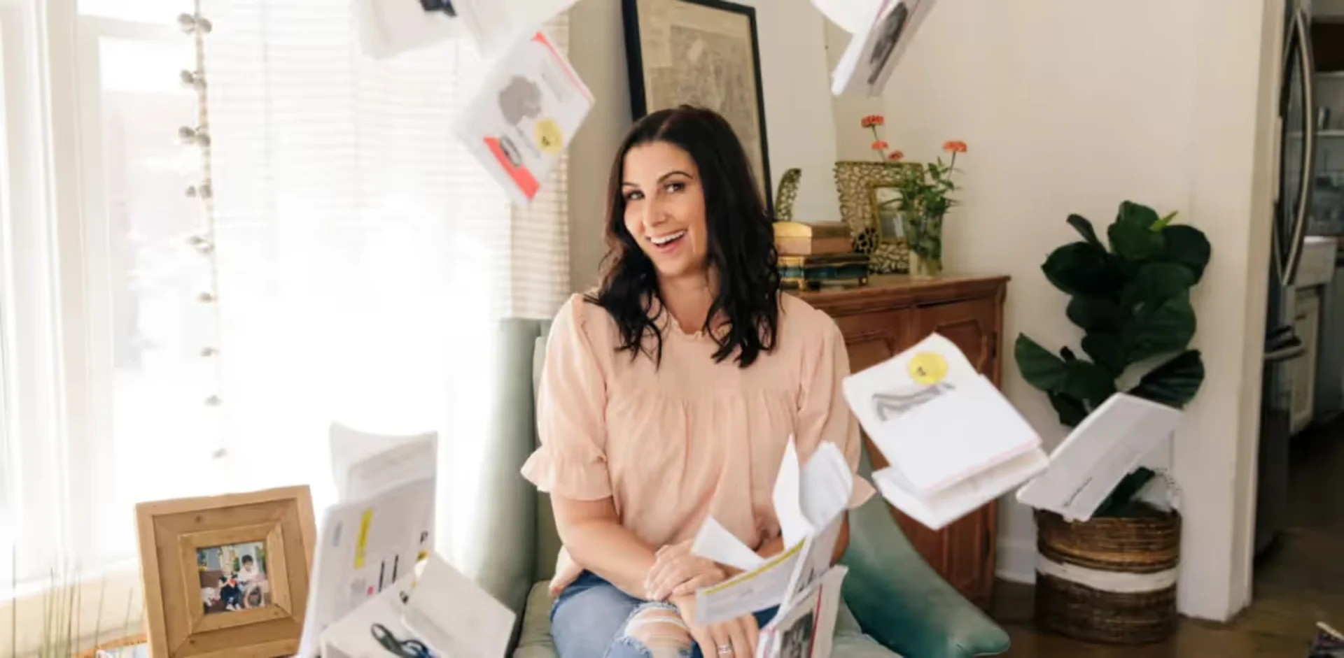 A woman sitting on a chair with a bunch of papers in front of her