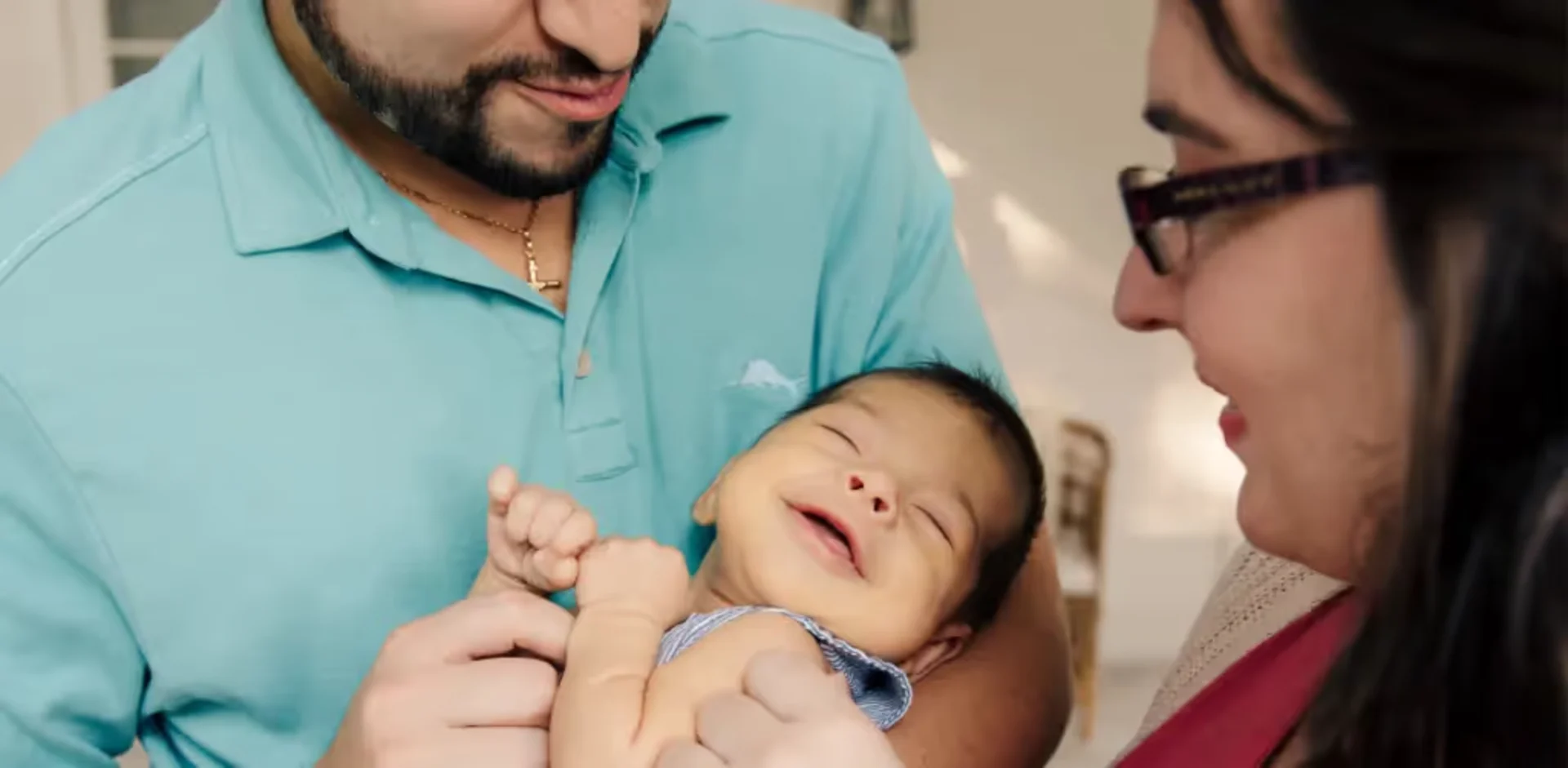 A man is holding a baby in his arms