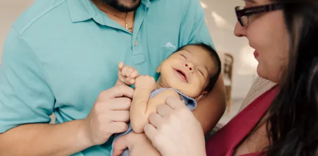 A man holding a baby in his arms