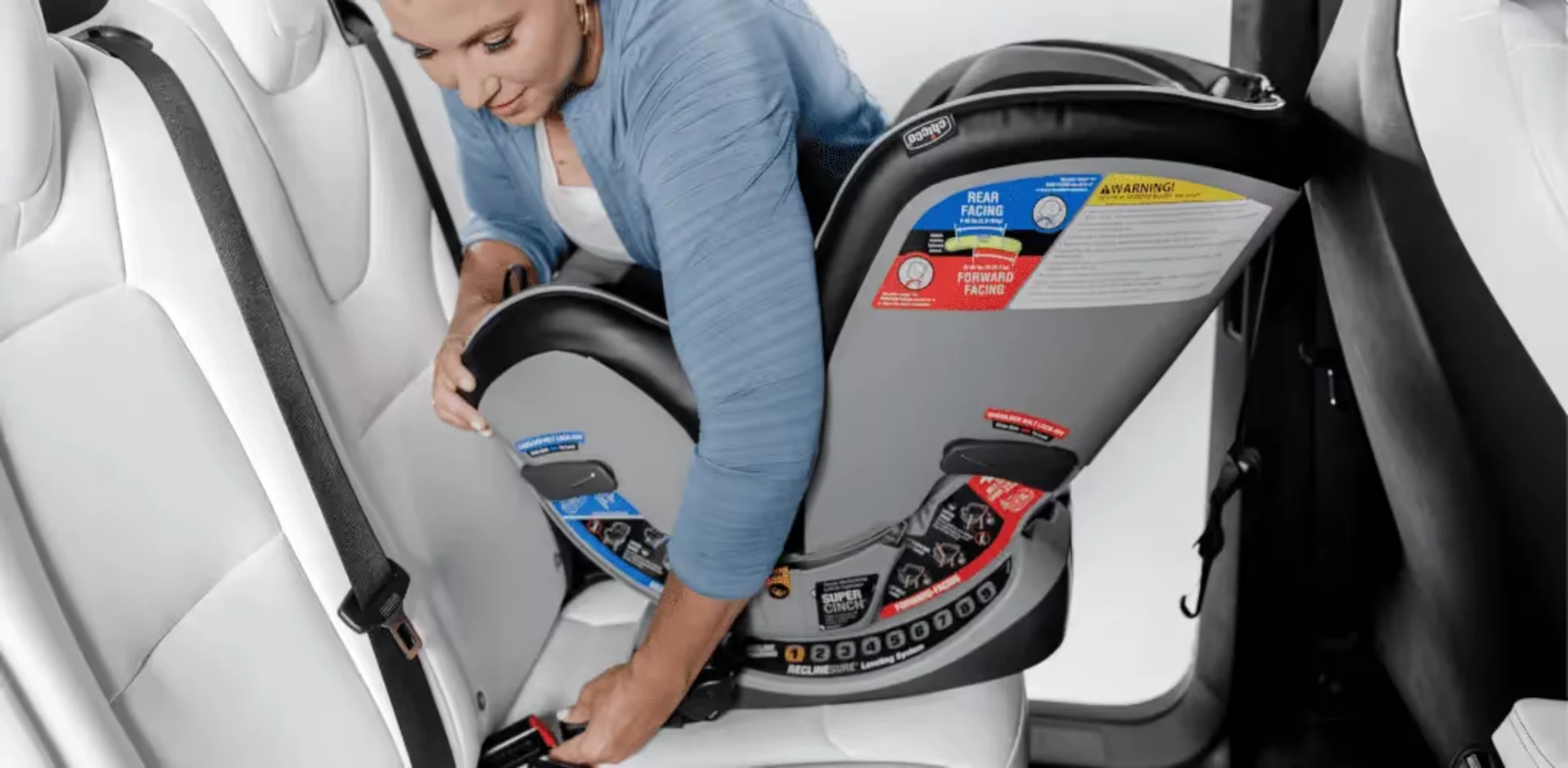 A woman putting the seat back in a car