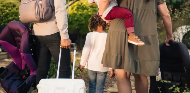 A group of people standing around with luggage