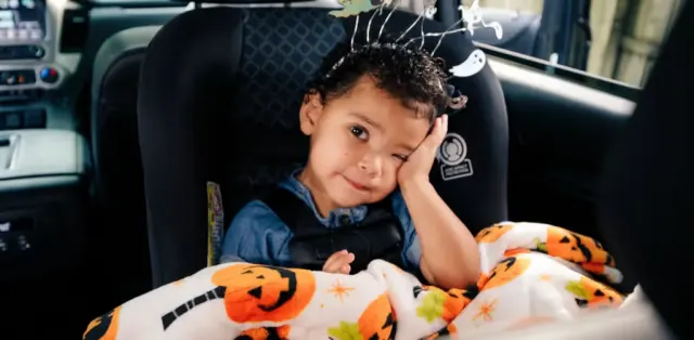 A small child sitting in a car seat
