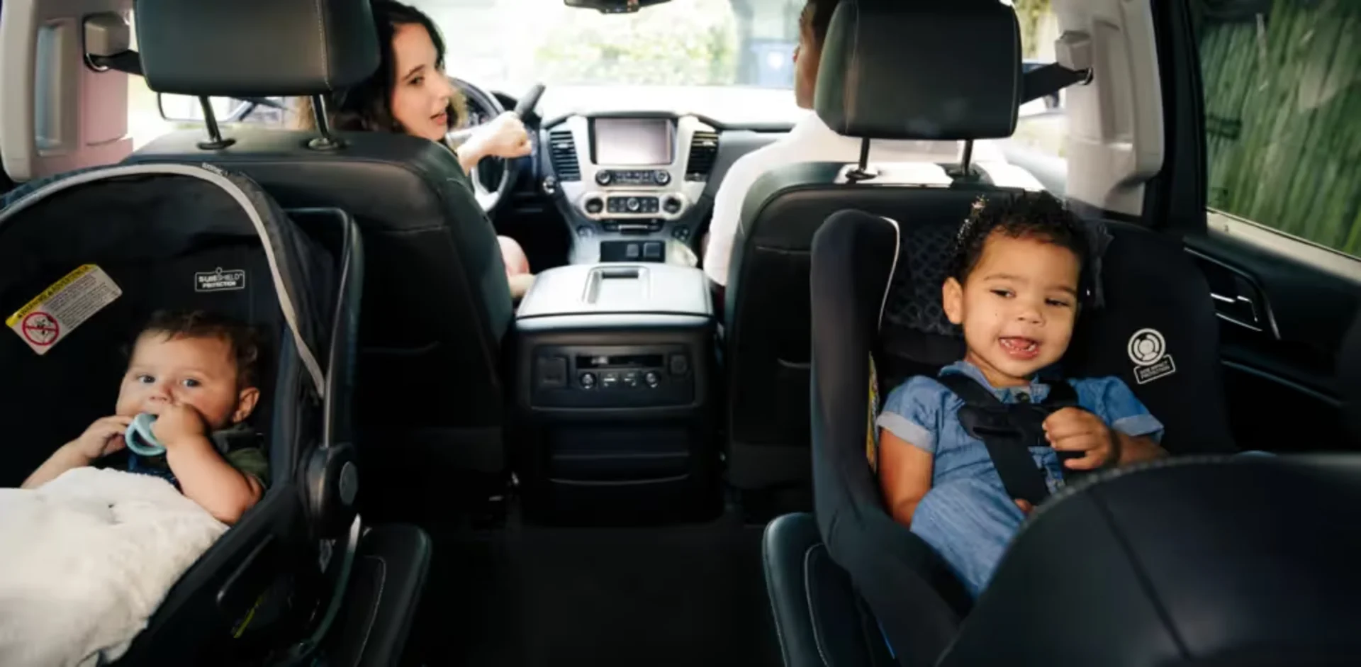 A woman and a child in a car seat