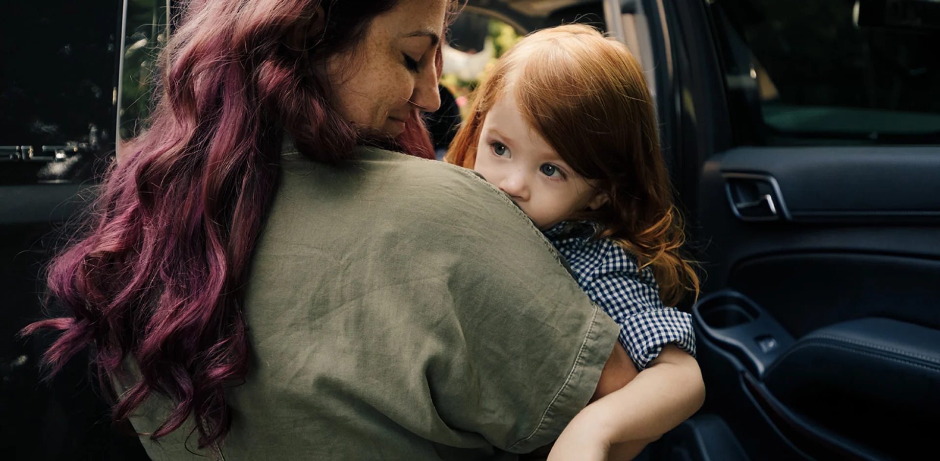 A woman holding a little girl in her arms