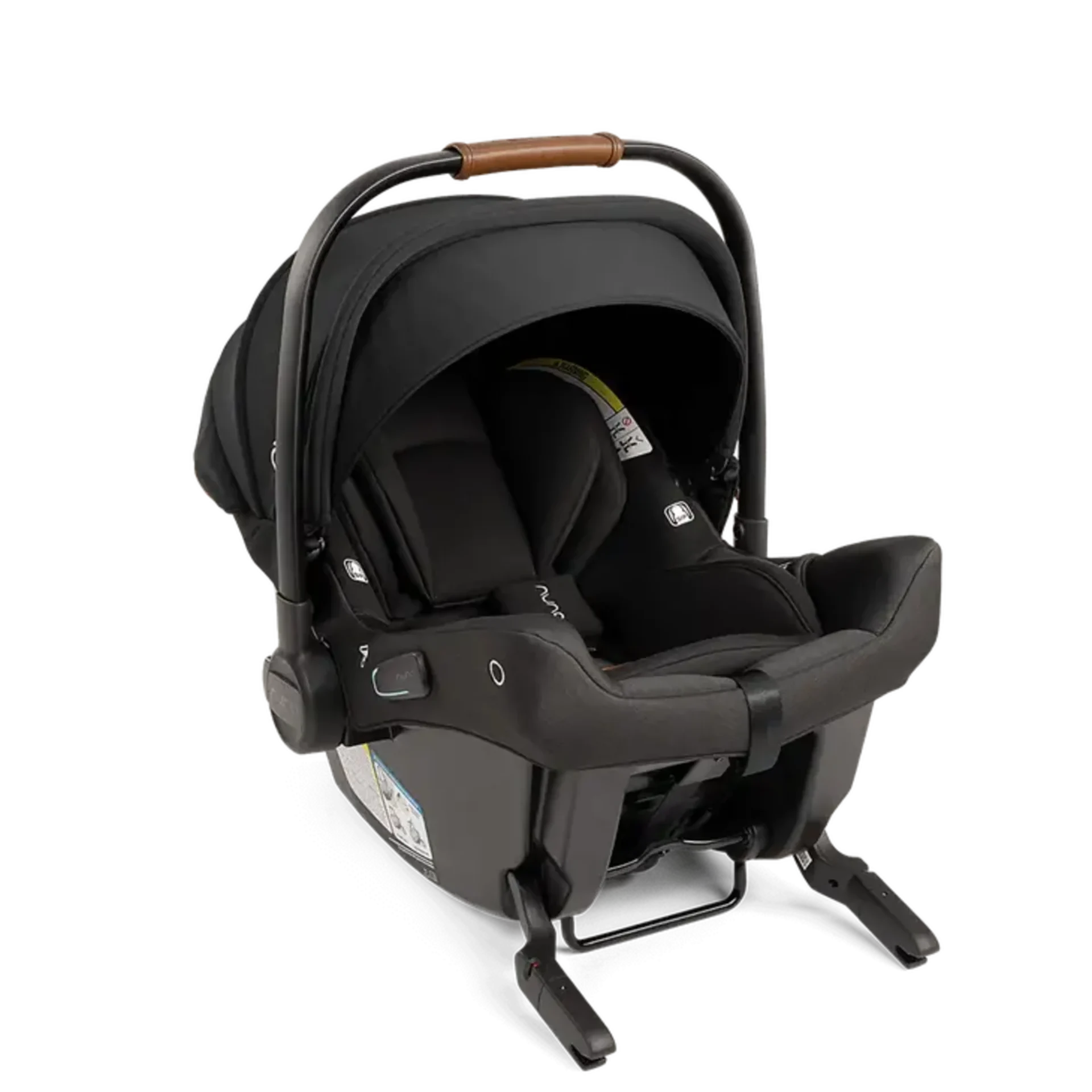 Nuna Pipa Urbn infant car seat in black with tan leather carry handle mounted on matching base against white background