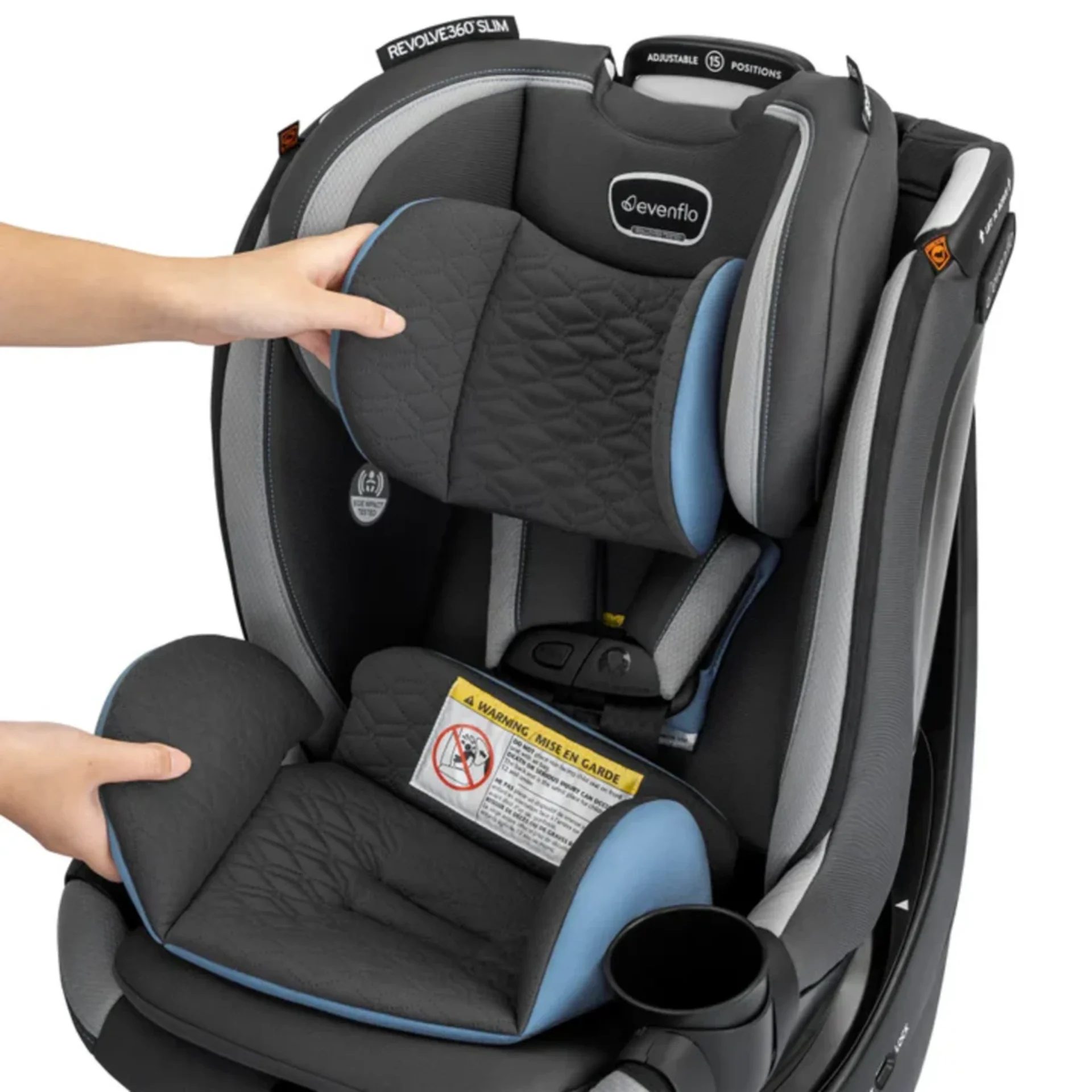 Hands adjusting the headrest and seat pad of the Evenflo Revolve360 Slim convertible car seat in charcoal gray and blue