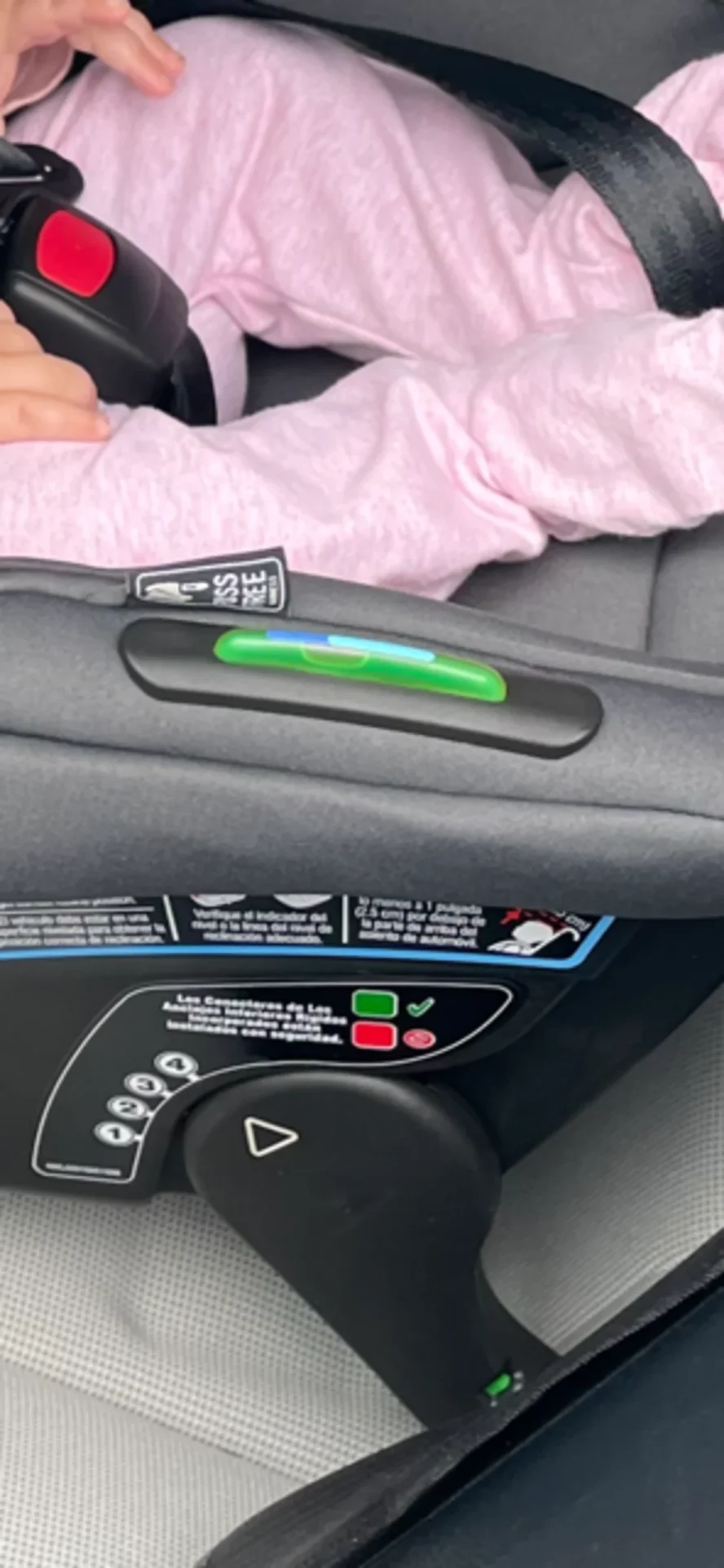 Graco GoMax baseless infant car seat showing green level indicator and LATCH connection status lights with baby in pink outfi
