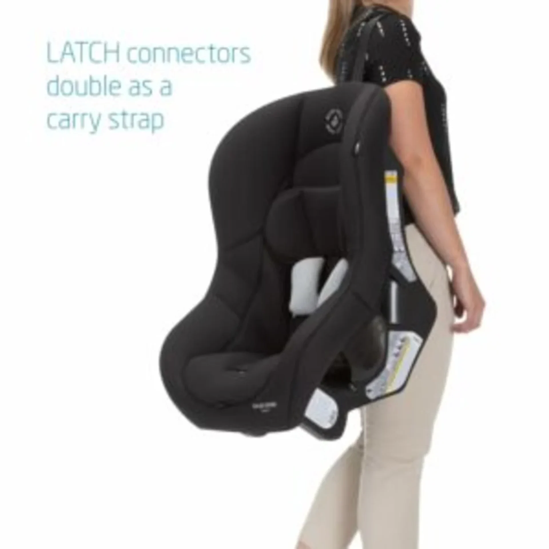 Woman carrying a black Maxi-Cosi Romi infant car seat using the LATCH connectors as a convenient carry strap