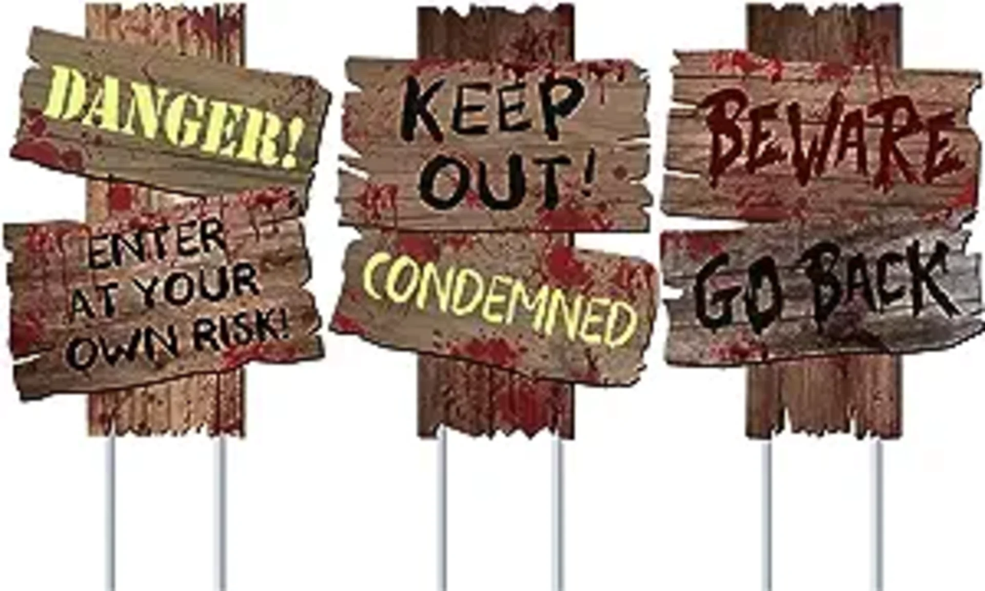 Three spooky Halloween yard signs on stakes reading Danger Enter At Your Own Risk, Keep Out Condemned, and Beware Go Back wit