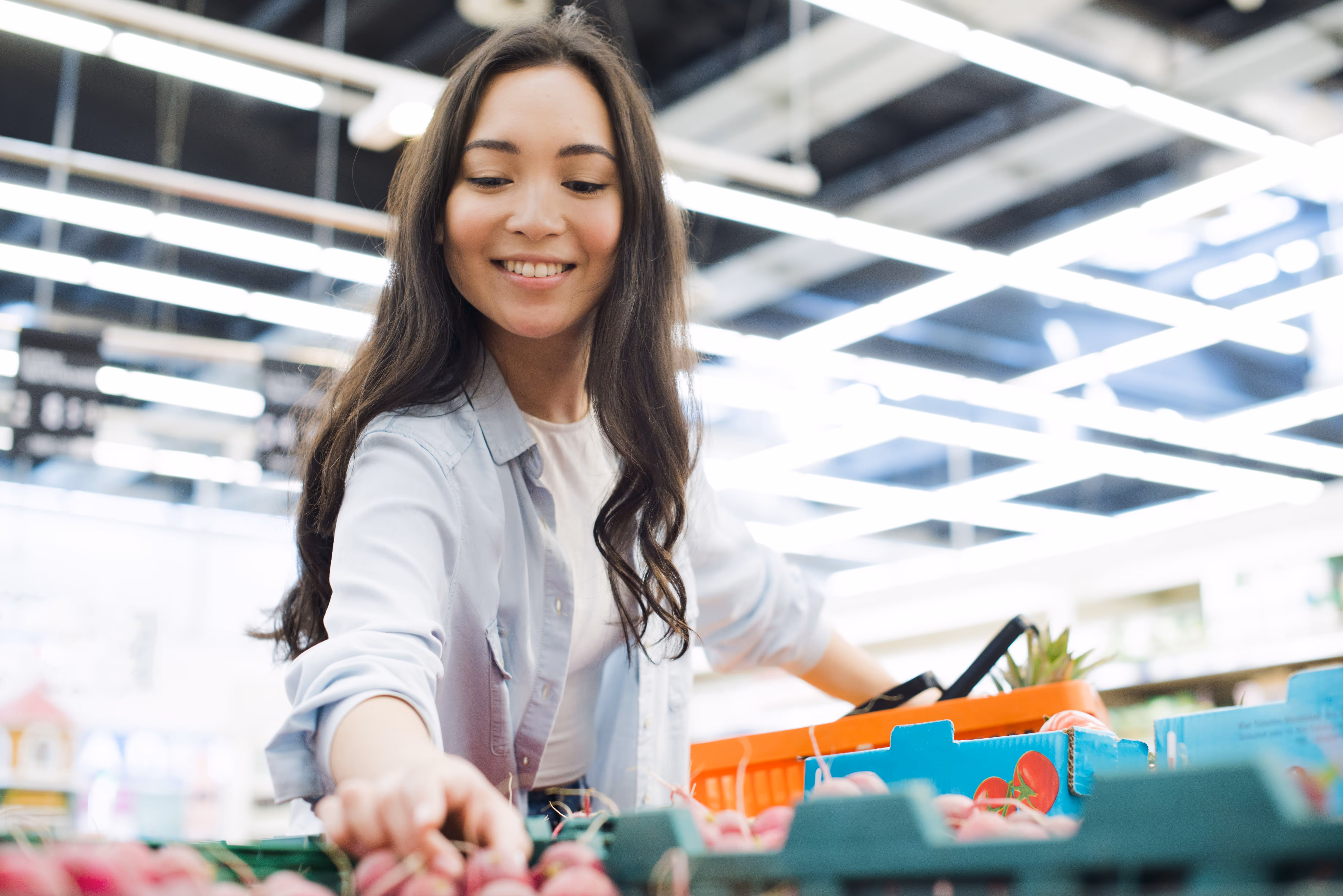 smiling-asian-woman-picking-radish-market
