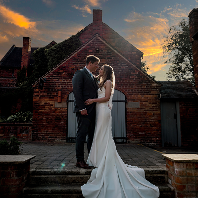 Couple embracing at sunset outside the barn at Blackbrook Barns, Lichfield, Staffordshire