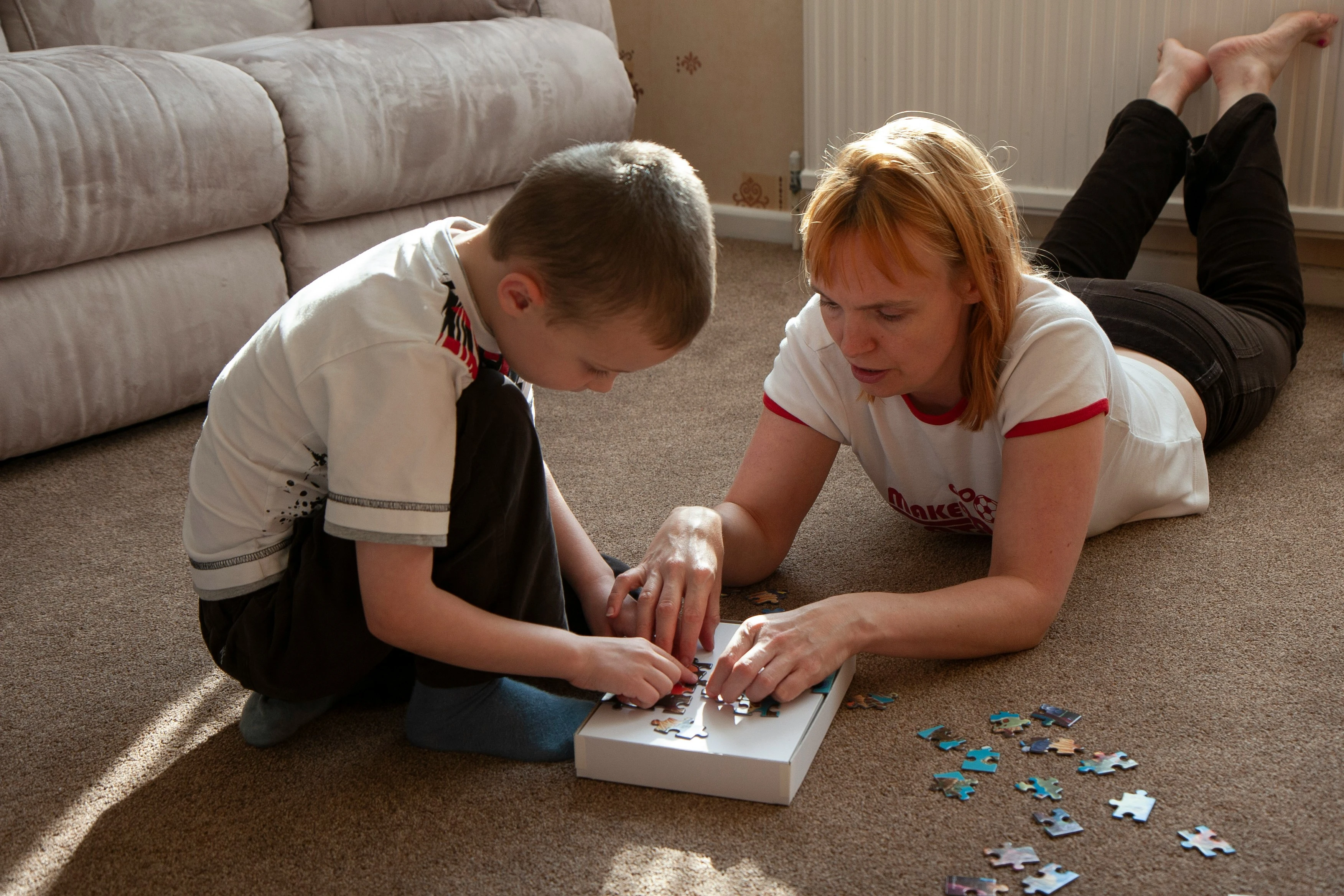 Woman and child playing with puzzles