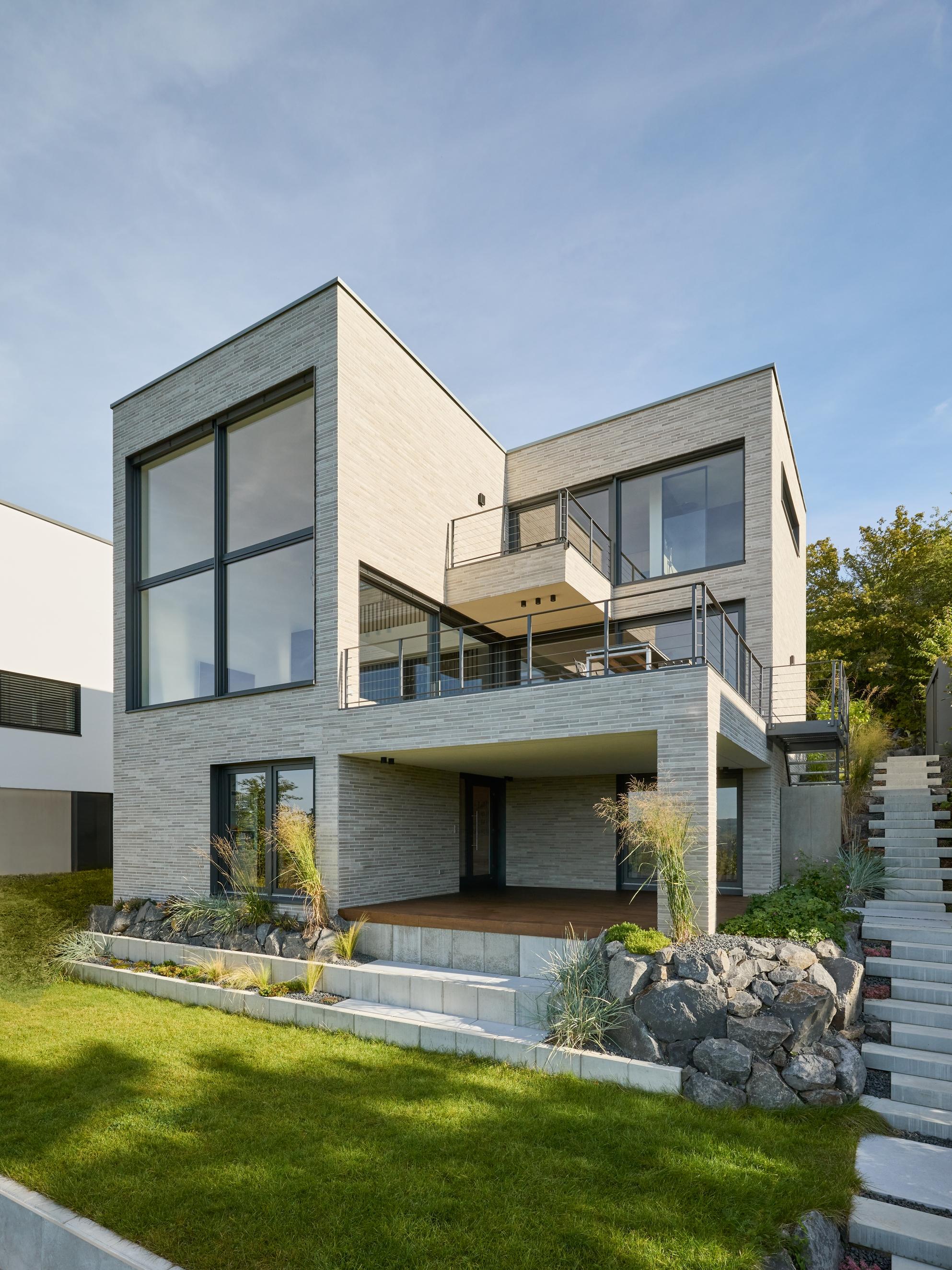 modern house with a staircase leading to the upper level