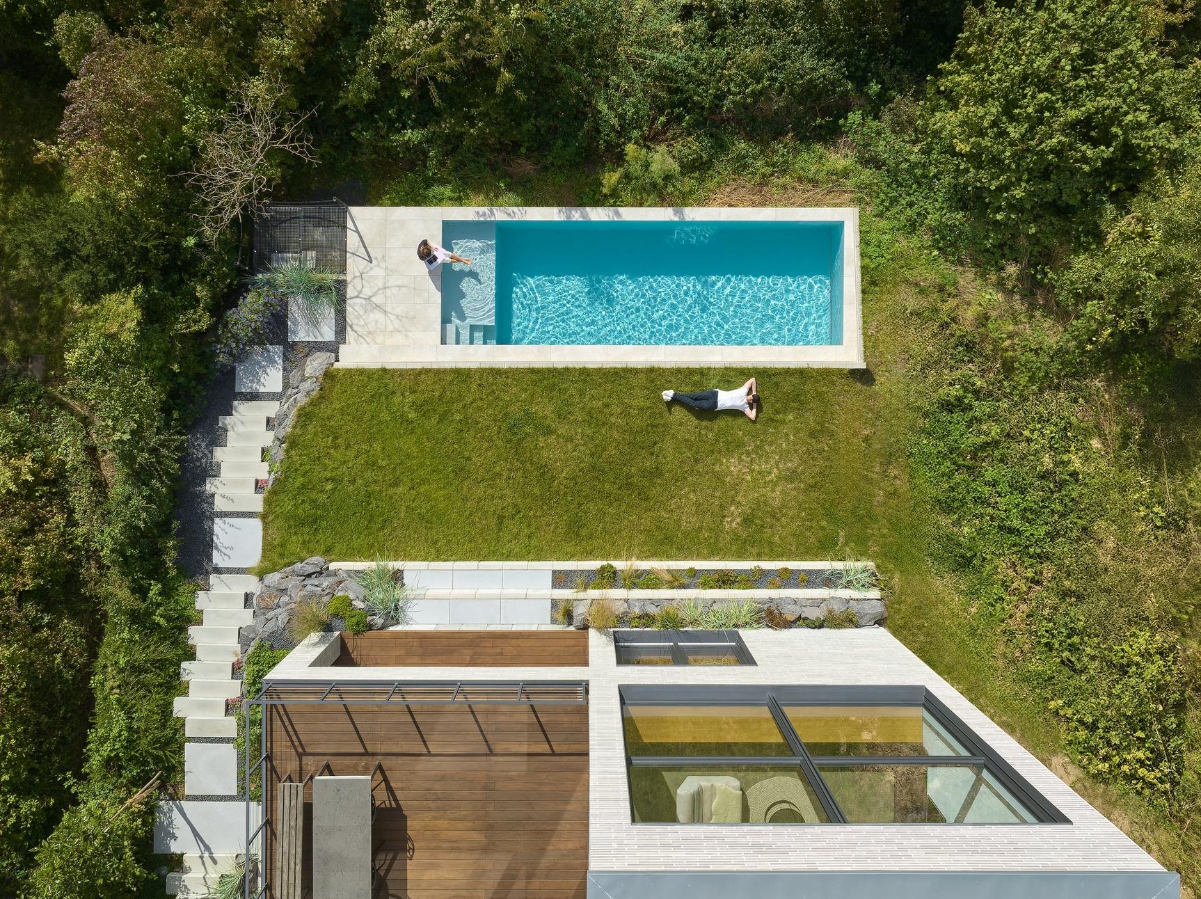 aerial view of a house with a pool and a garden