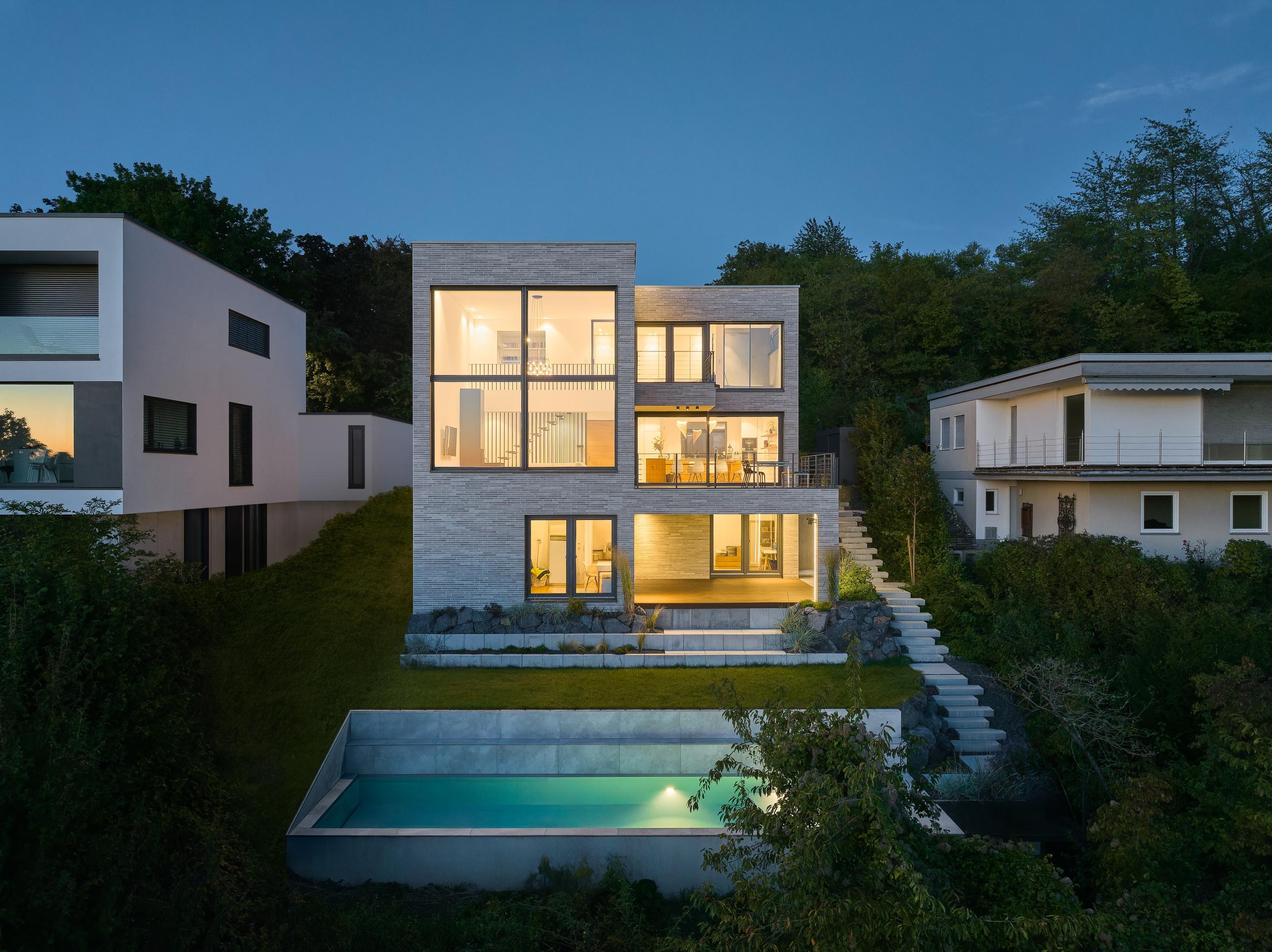 a view of a house with a pool in the backyard