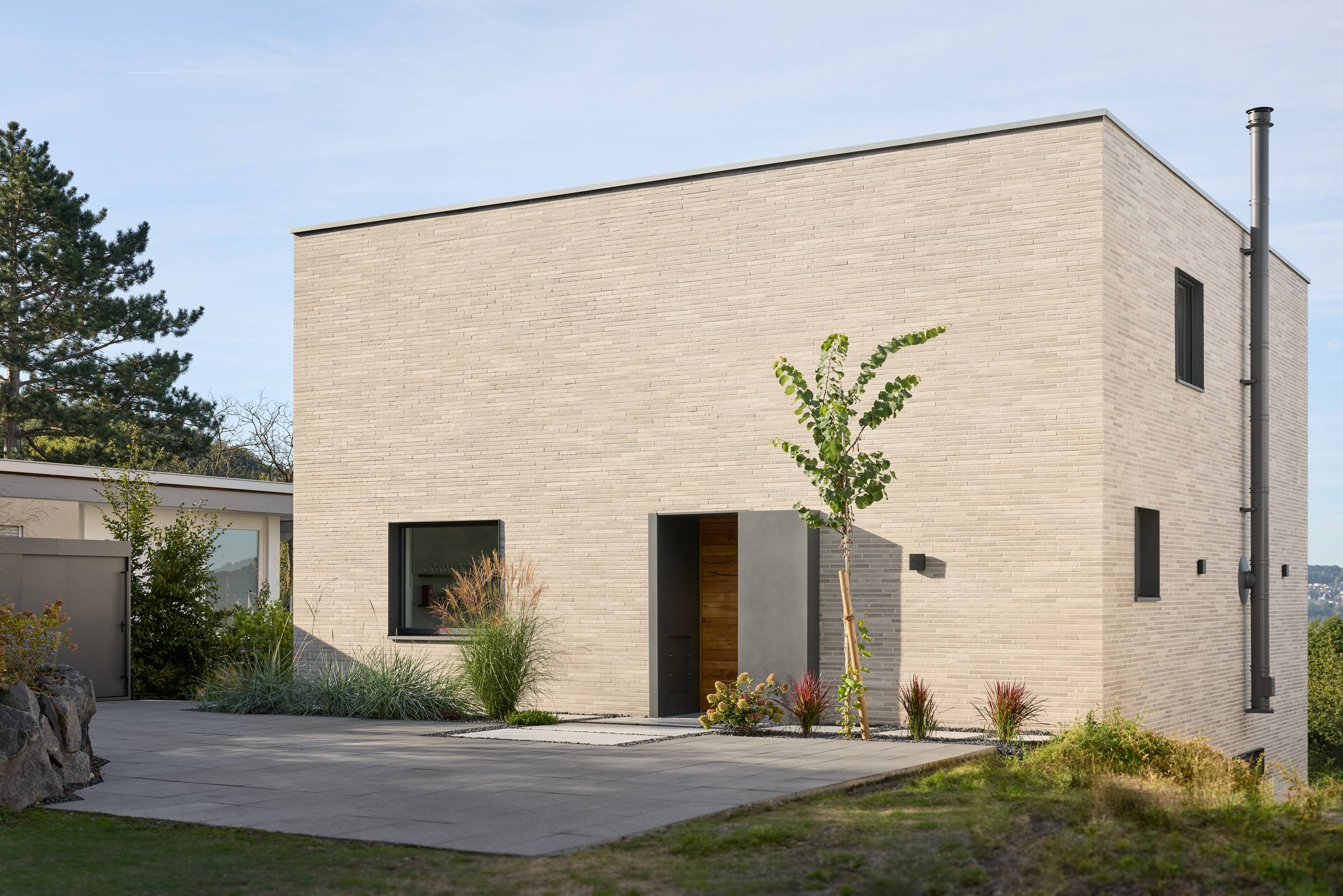 there is a small house with a tree in the front yard