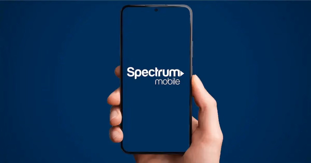 Hand holding phone with Spectrum mobile logo on the screen