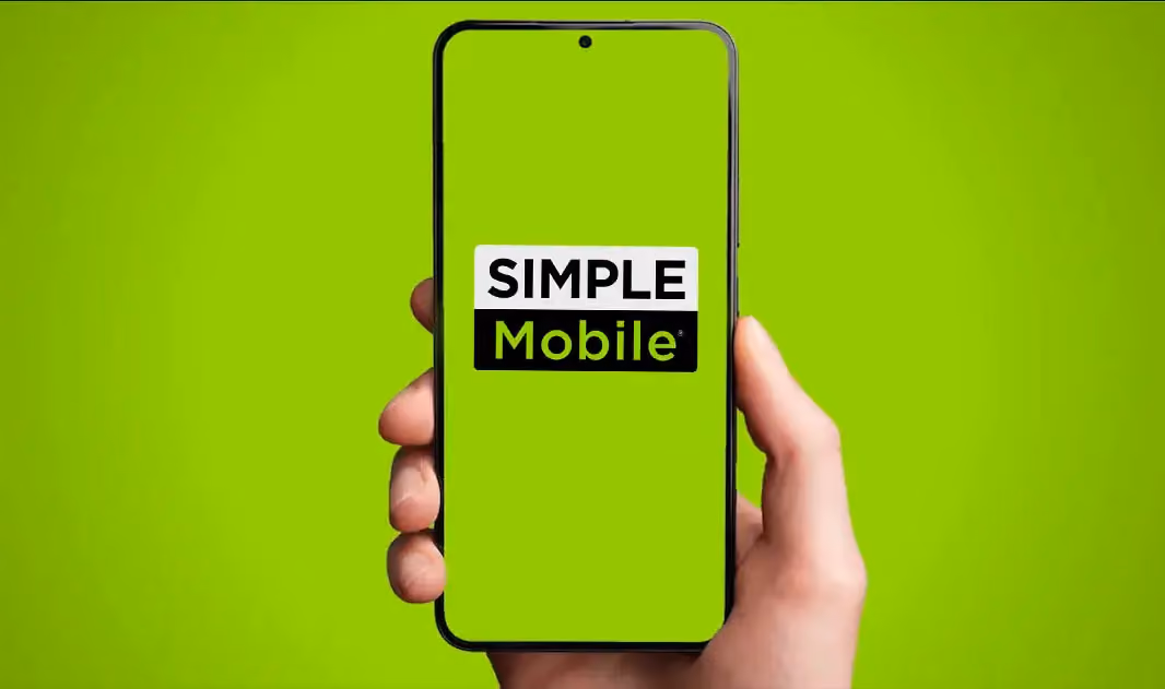 Hand holding phone with simple mobile logo on the screen