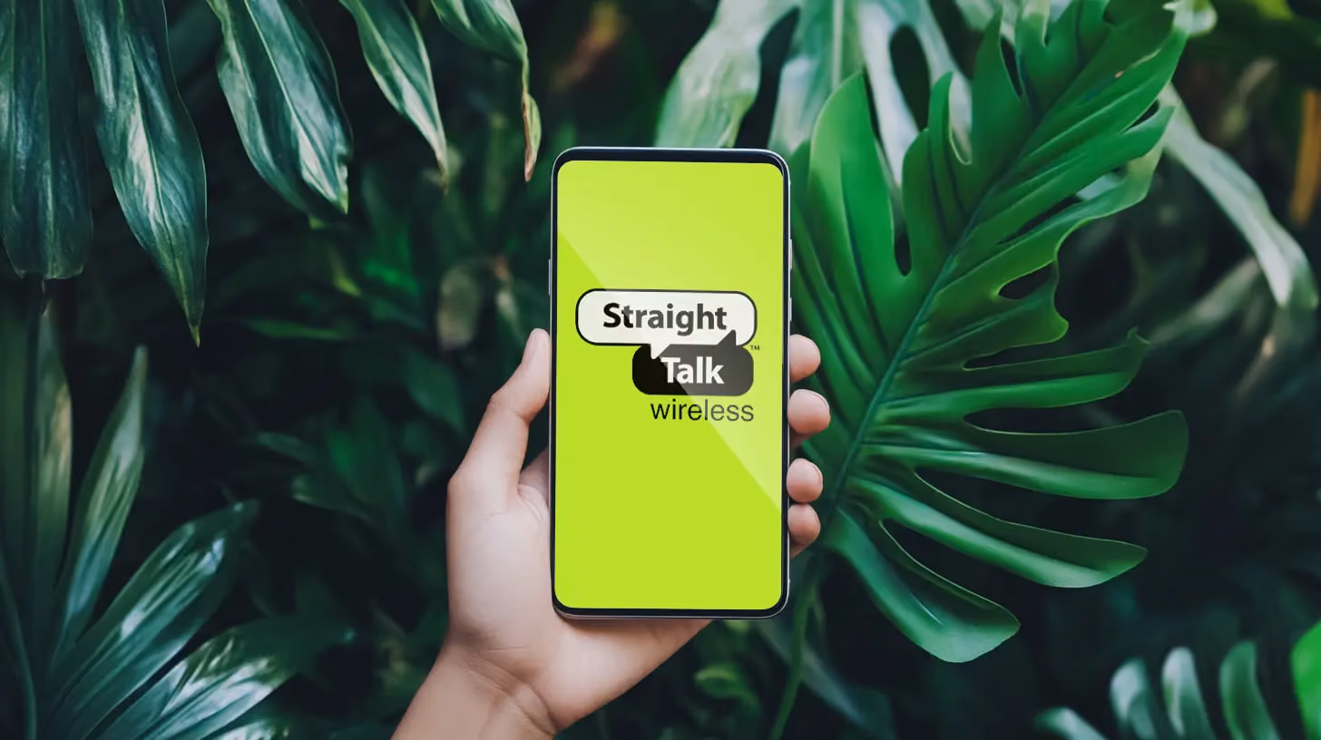 Hand holding phone with Straight Talk logo on the screen