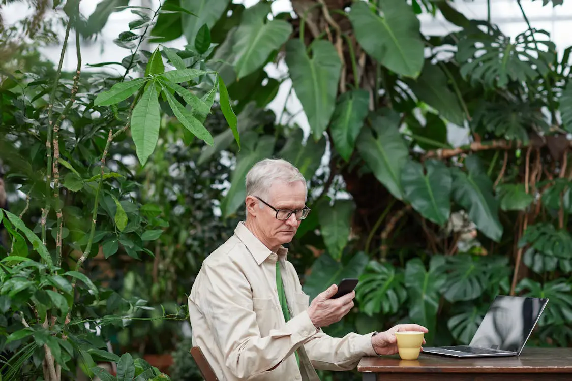Free Man Looking at His Smartphone Stock Photo