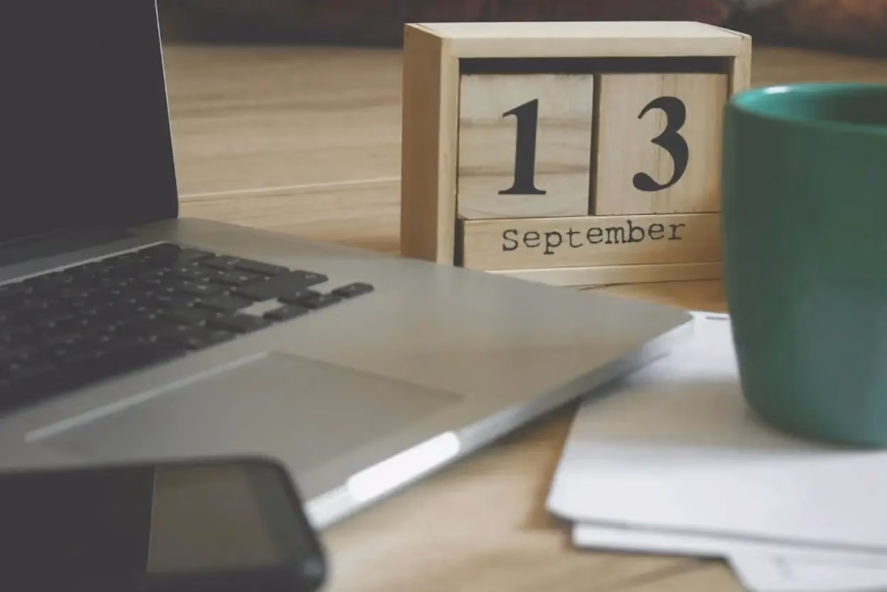 a laptop and a calendar on a table