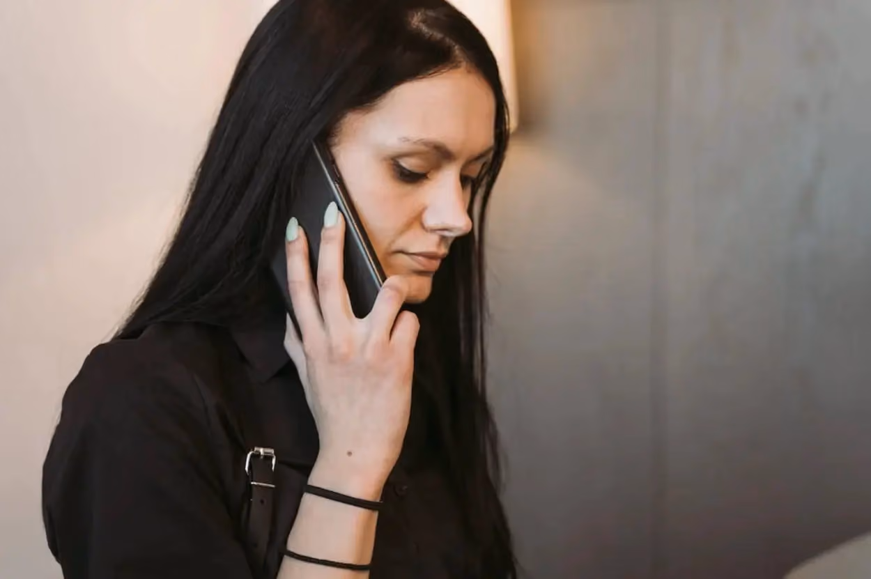 a person holding a phone to her ear