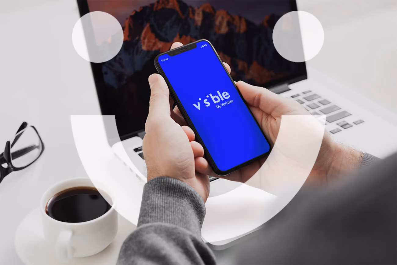 Hand holding phone with visible wireless logo on the screen