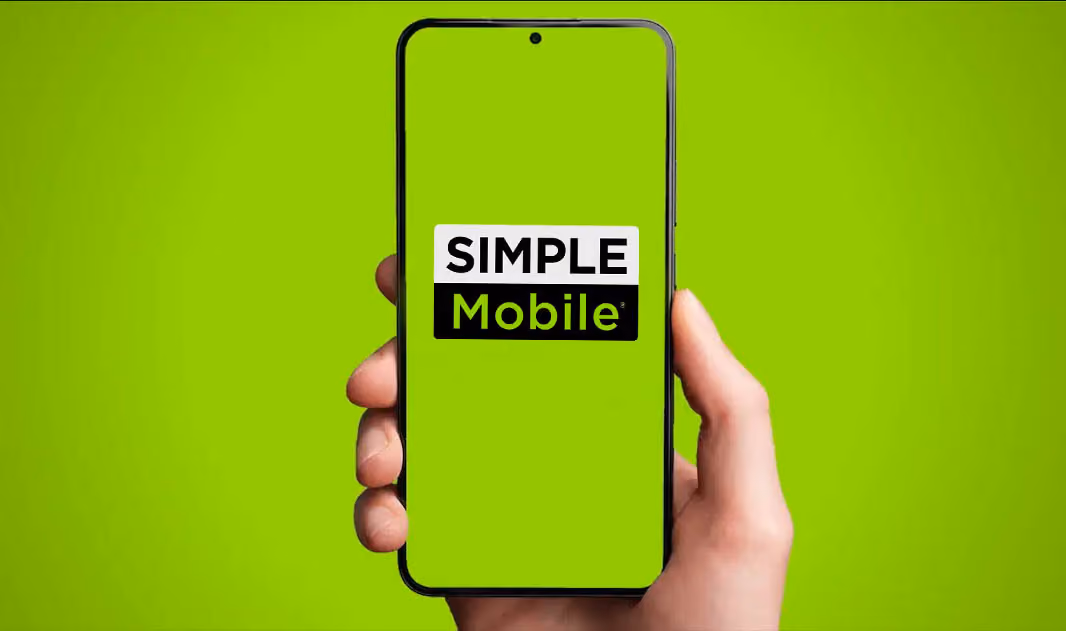 A person holding a smartphone with simple mobile logo on the screen