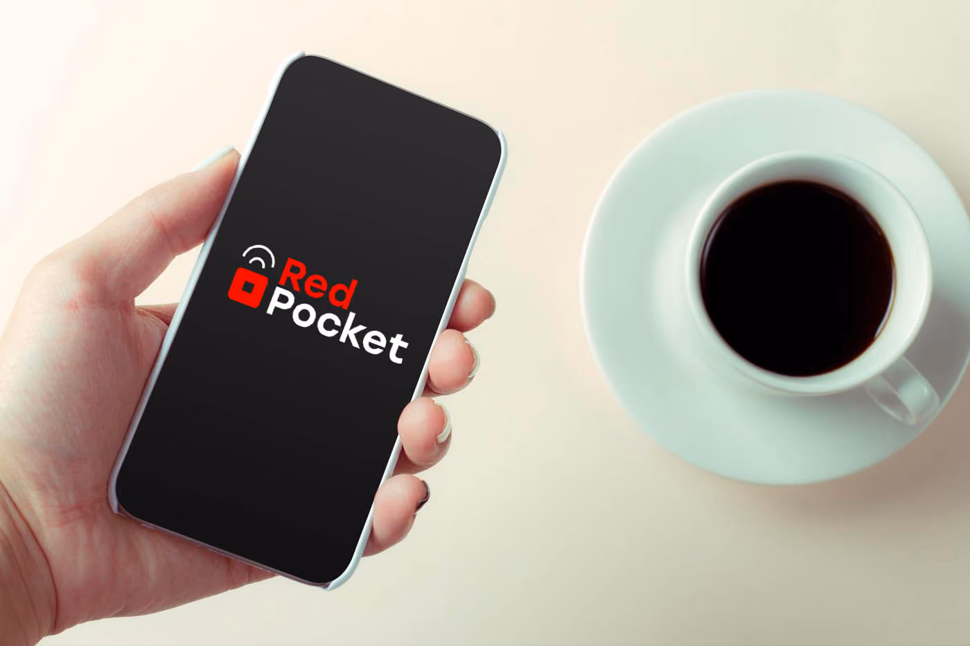 A person holding iphone with Red Pocket logo on the screen