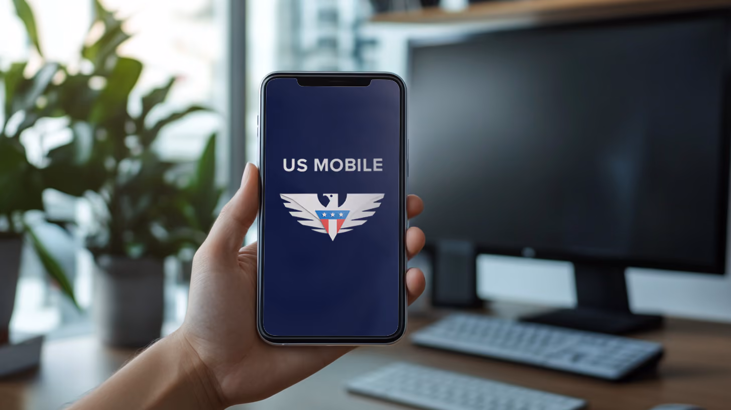 A person holding iphone with Visible Wireless logo on the screen