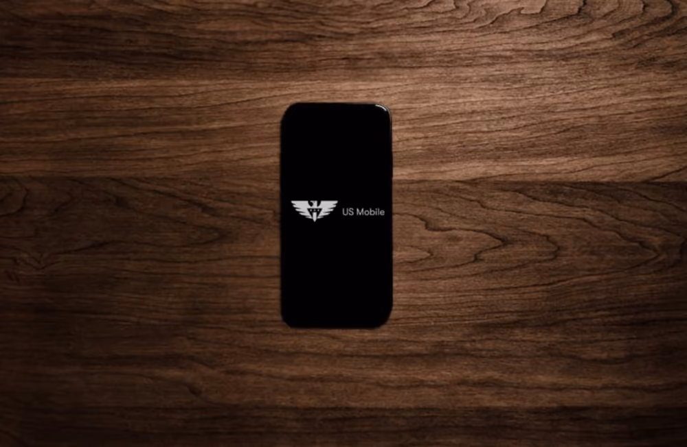 Smartphone on the top of desk with US Mobile ogo on the screen