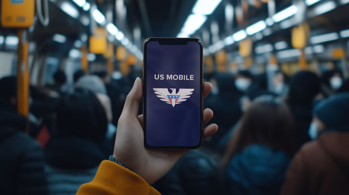 A person holding iphone with US Mobile logo on the screen