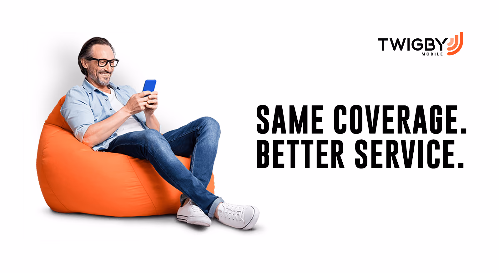 A man relaxes on an orange bean bag chair, engrossed in his phone, creating a casual and comfortable atmosphere.