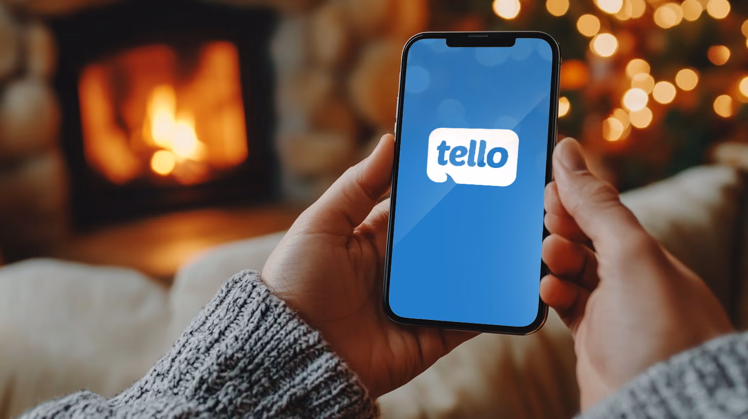 Hand holding phone with tello logo on the screen