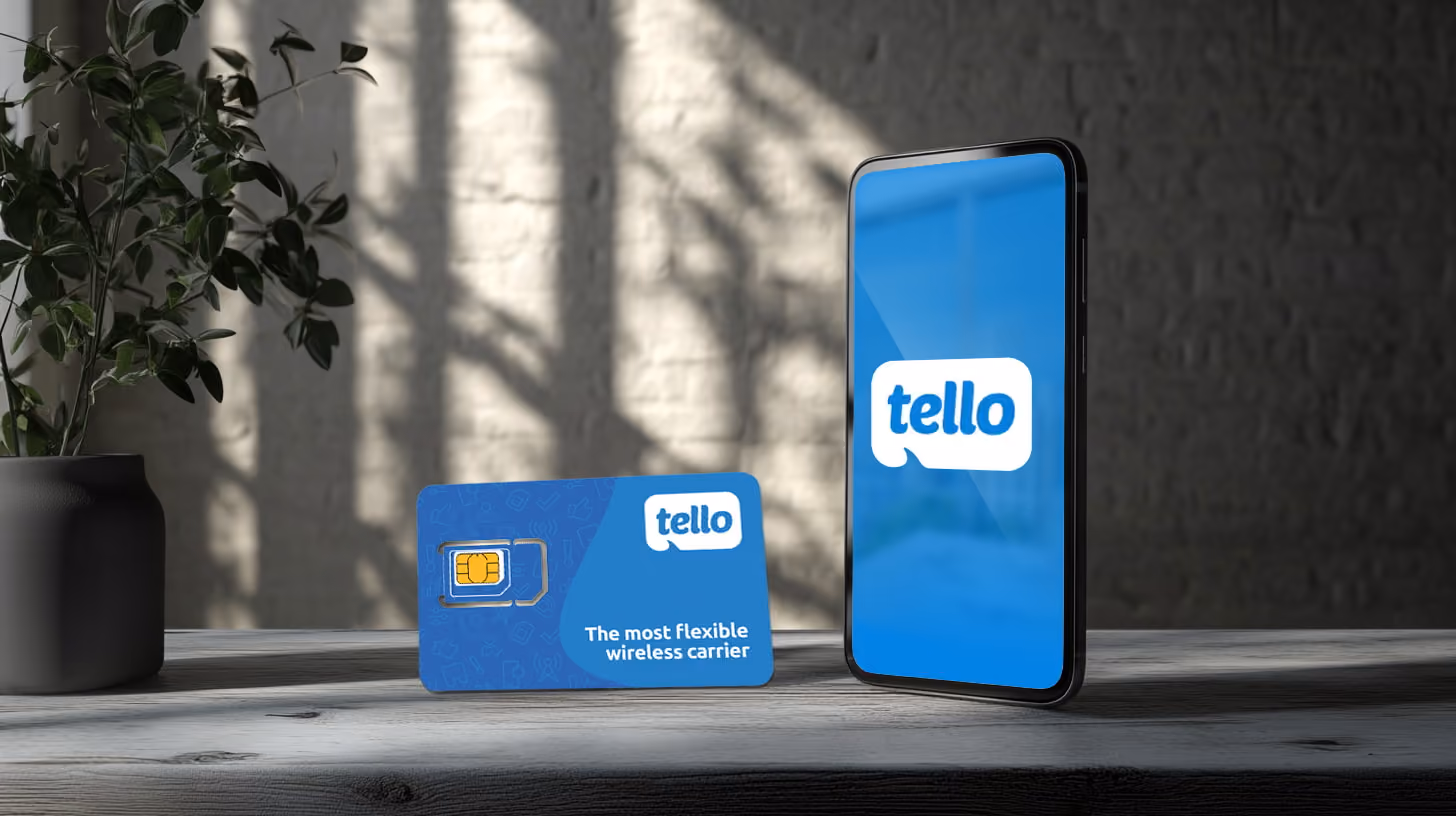 a mobile phone standing on a table, with tello logo on the screen