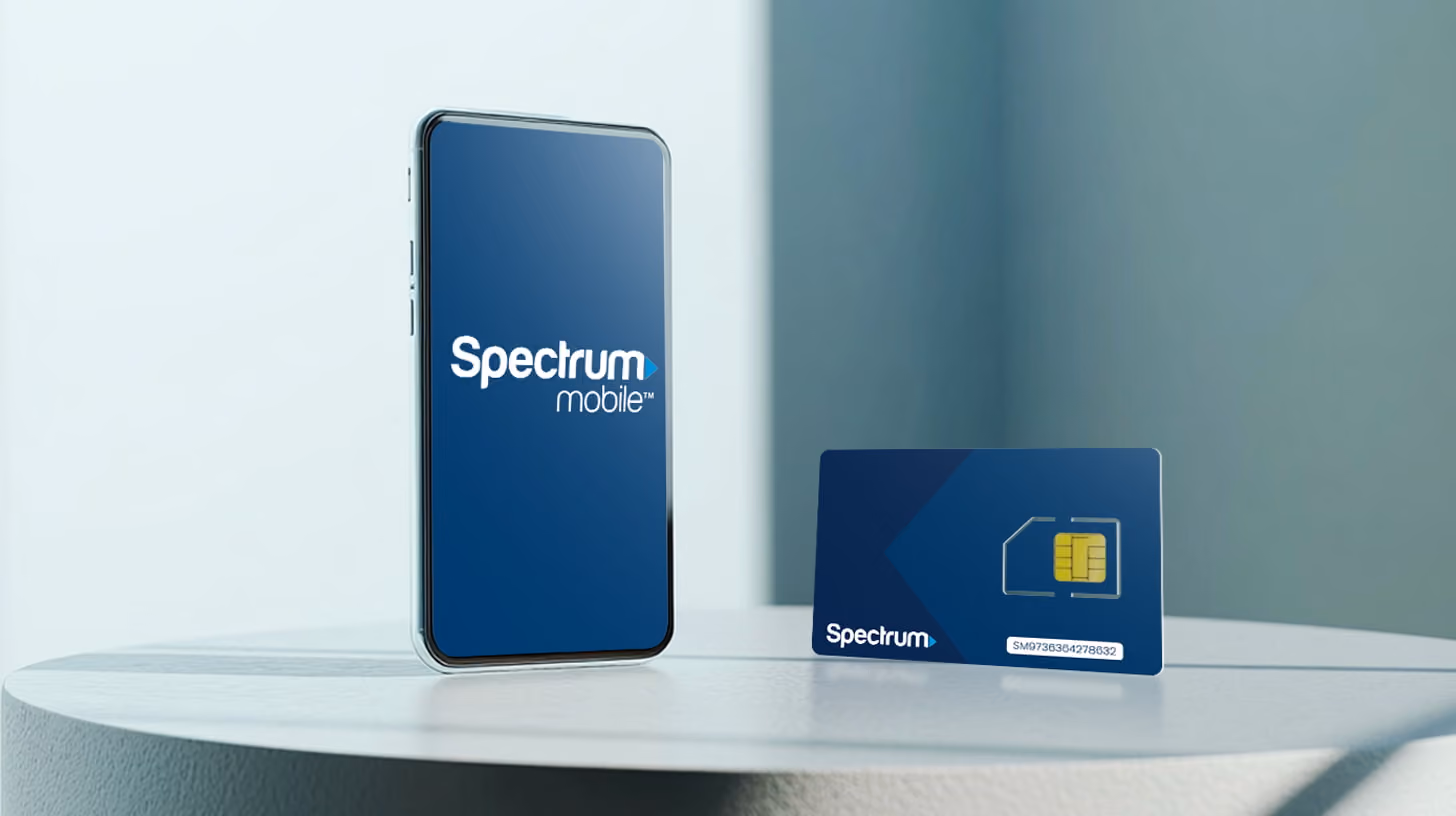 a mobile phone standing on a table, with Spectrum Mobile logo on the screen