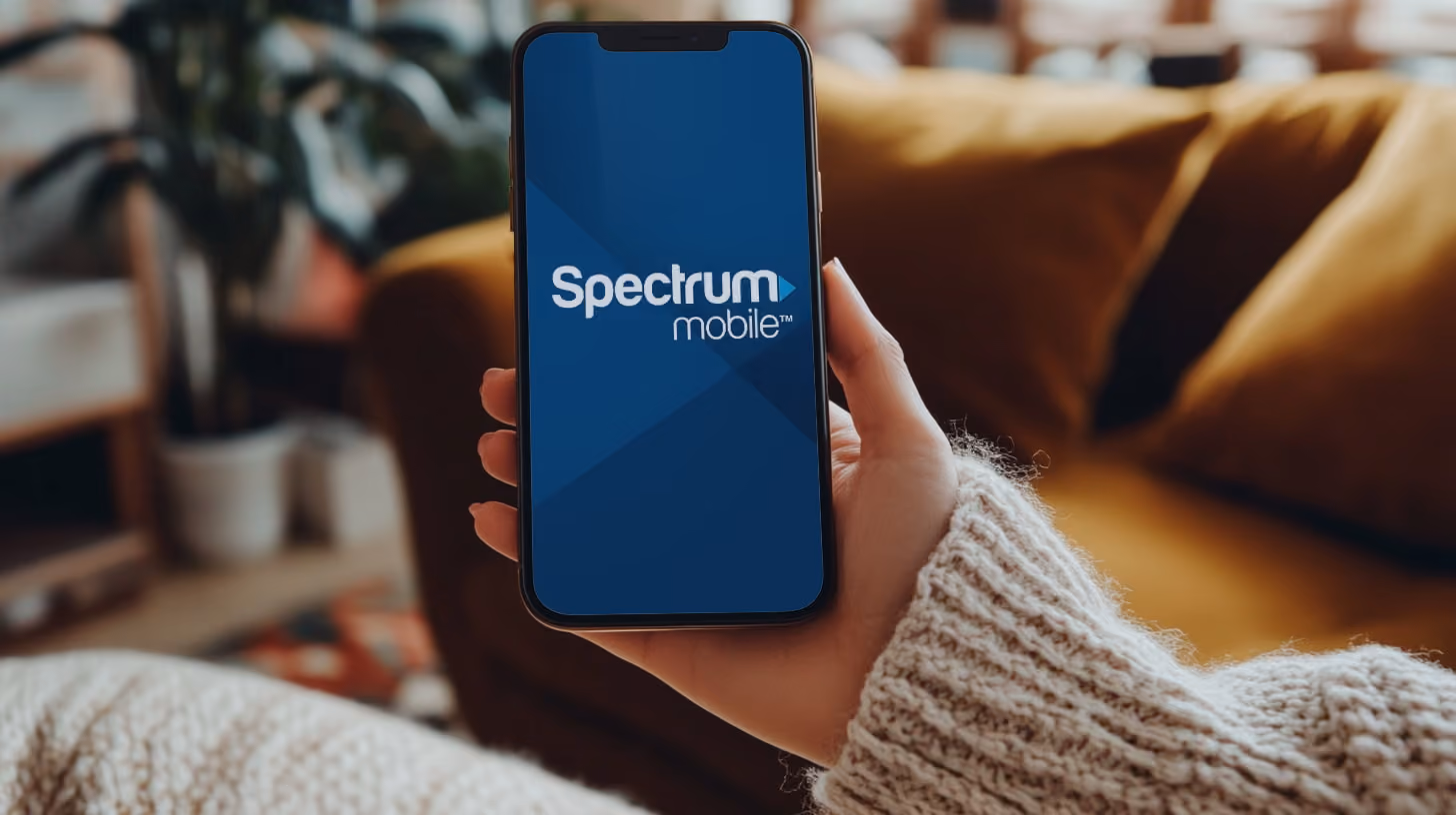 A person holding smartphone with spectrum mobile on the screen