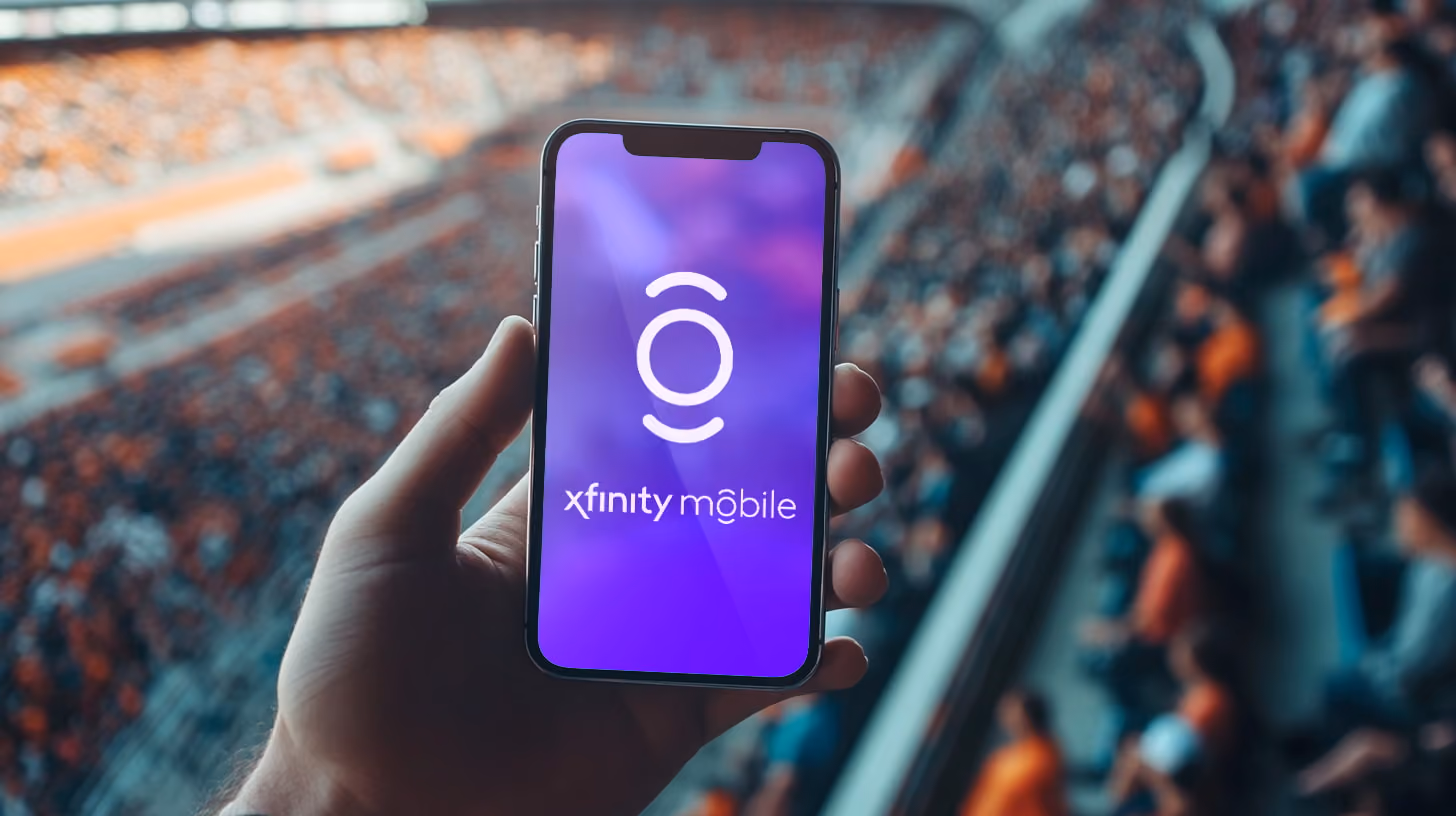 Hand holding a smartphone with Xfinity logo on the screen