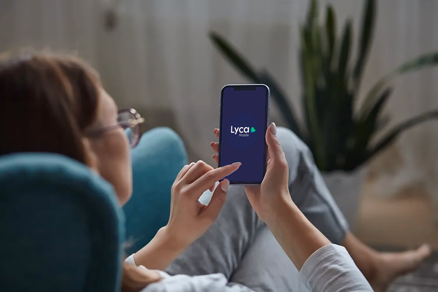 A woman engaged with a mobile app on her smartphone, focused and immersed in her digital experience.