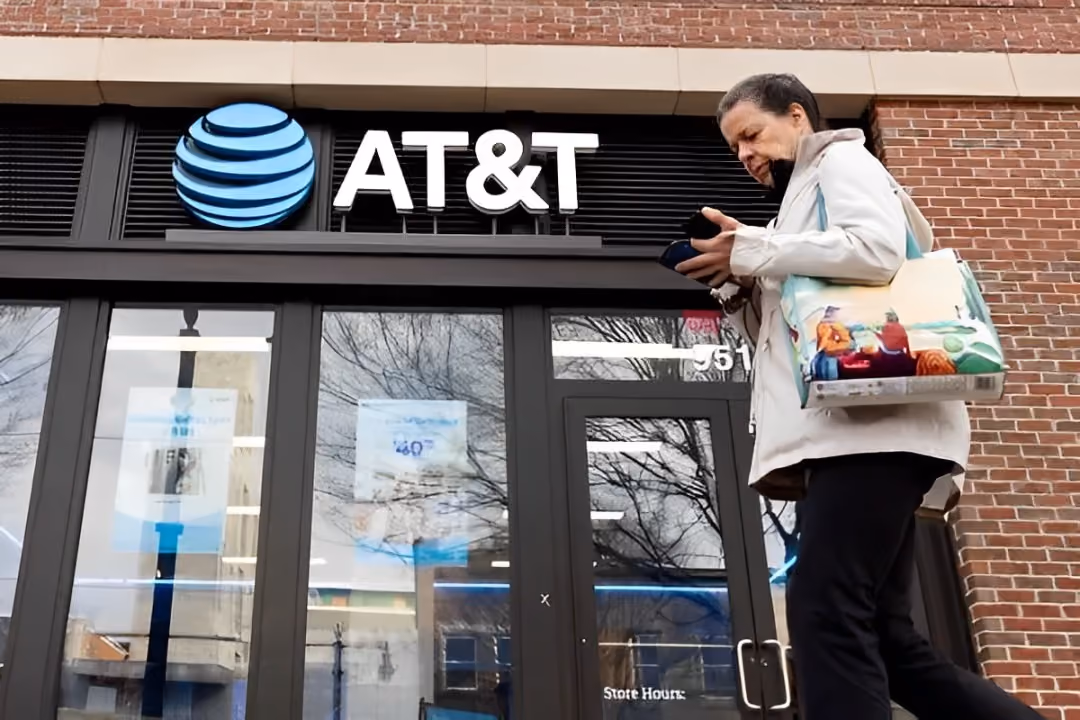A woman walking in the front of AT&T Store