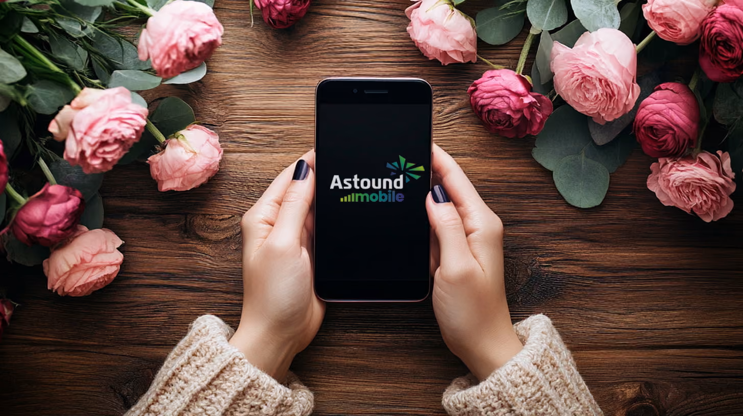 A person holding a phone with Astound Mobile