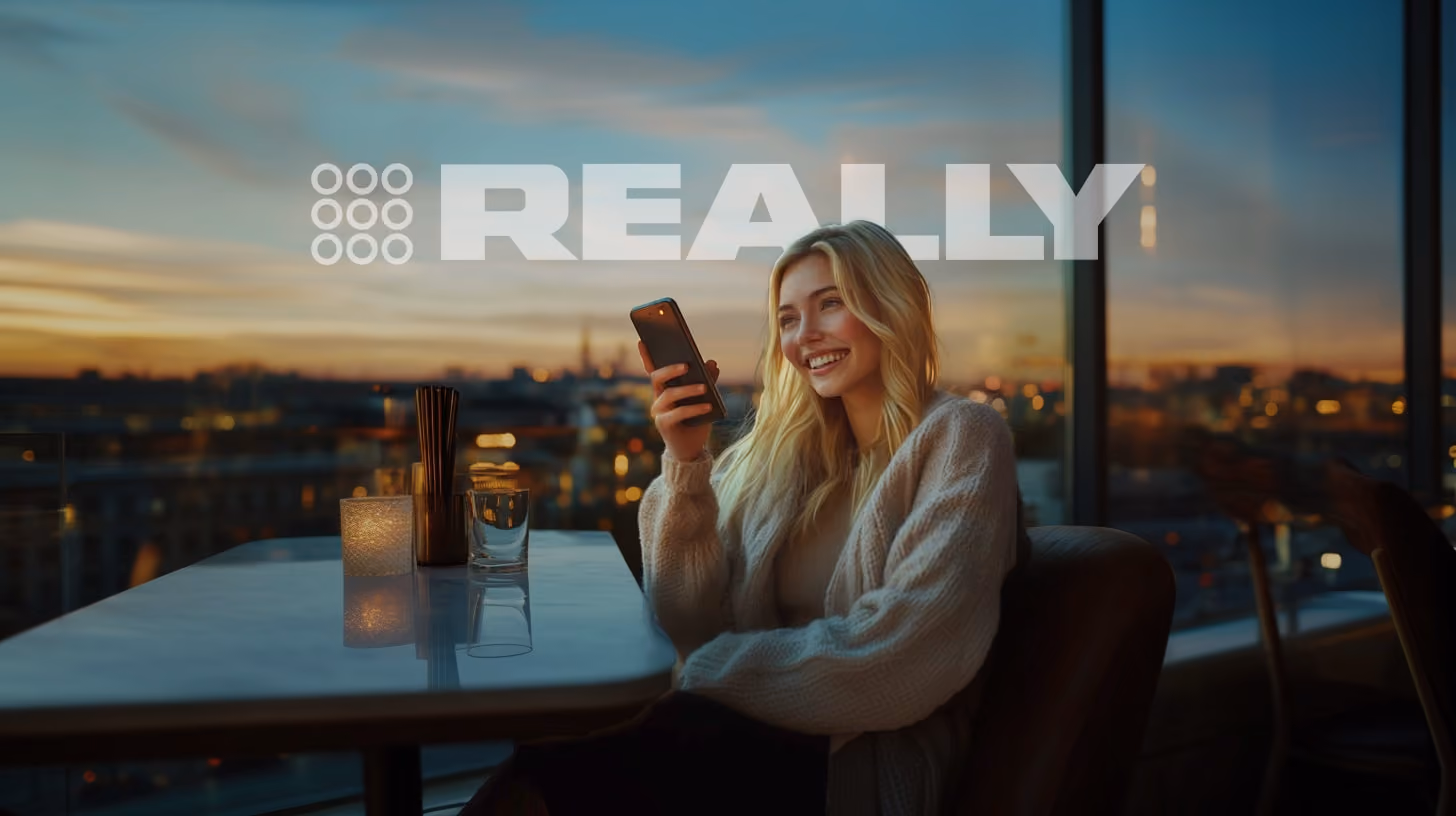 A person calling someone with his phone, at the rooftop bar, REALLY Wireless logo on the background