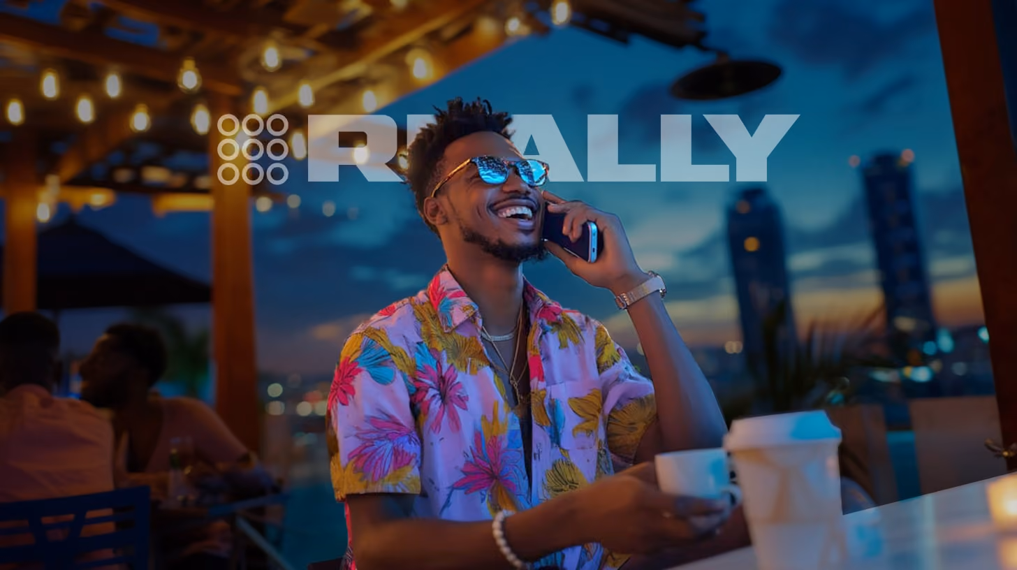 smiling man calling someone with his phone, standing at roof top bar, happy vibes