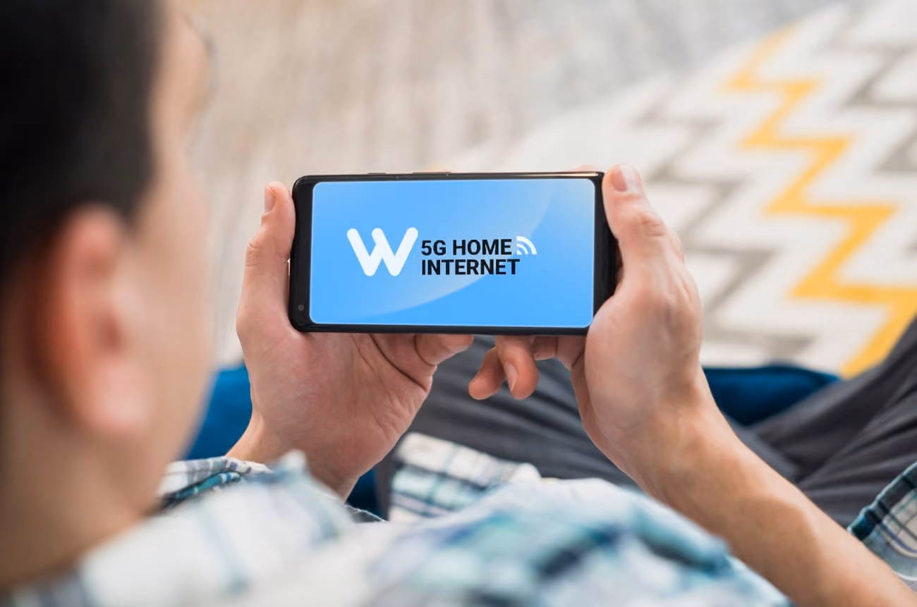 Man looking at smartphone on settee