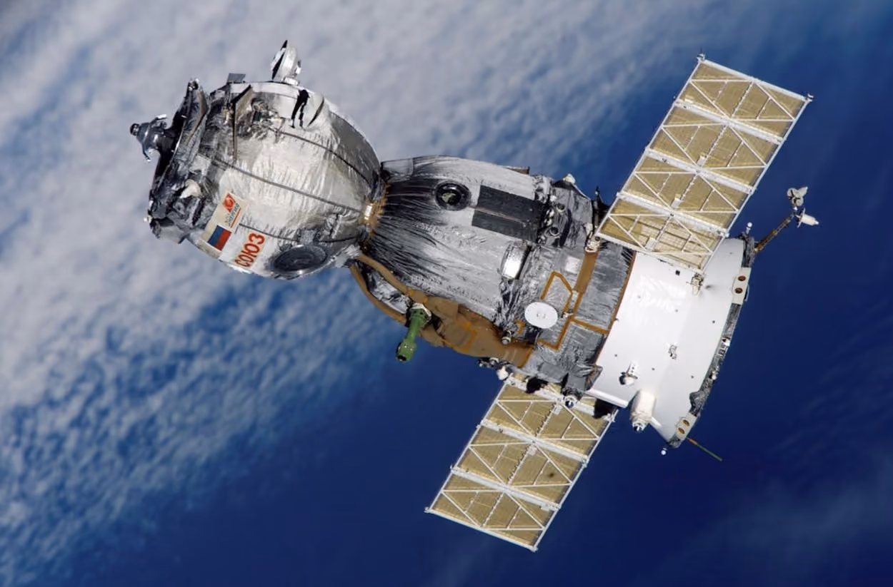 Aerial view of the space station, showcasing its intricate structure against the backdrop of Earth and space.
