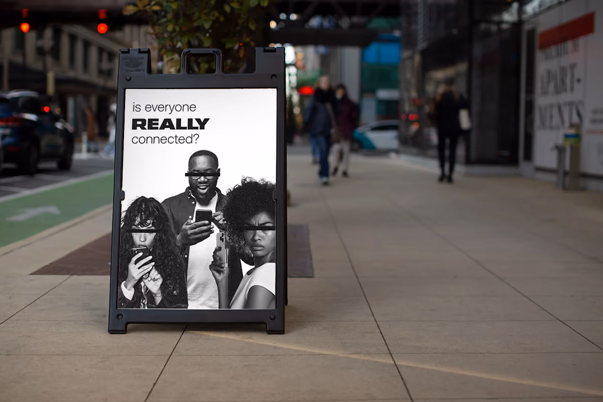 A sidewalk sign promoting REALLY Wireless , featuring vibrant colors and enticing food imagery.