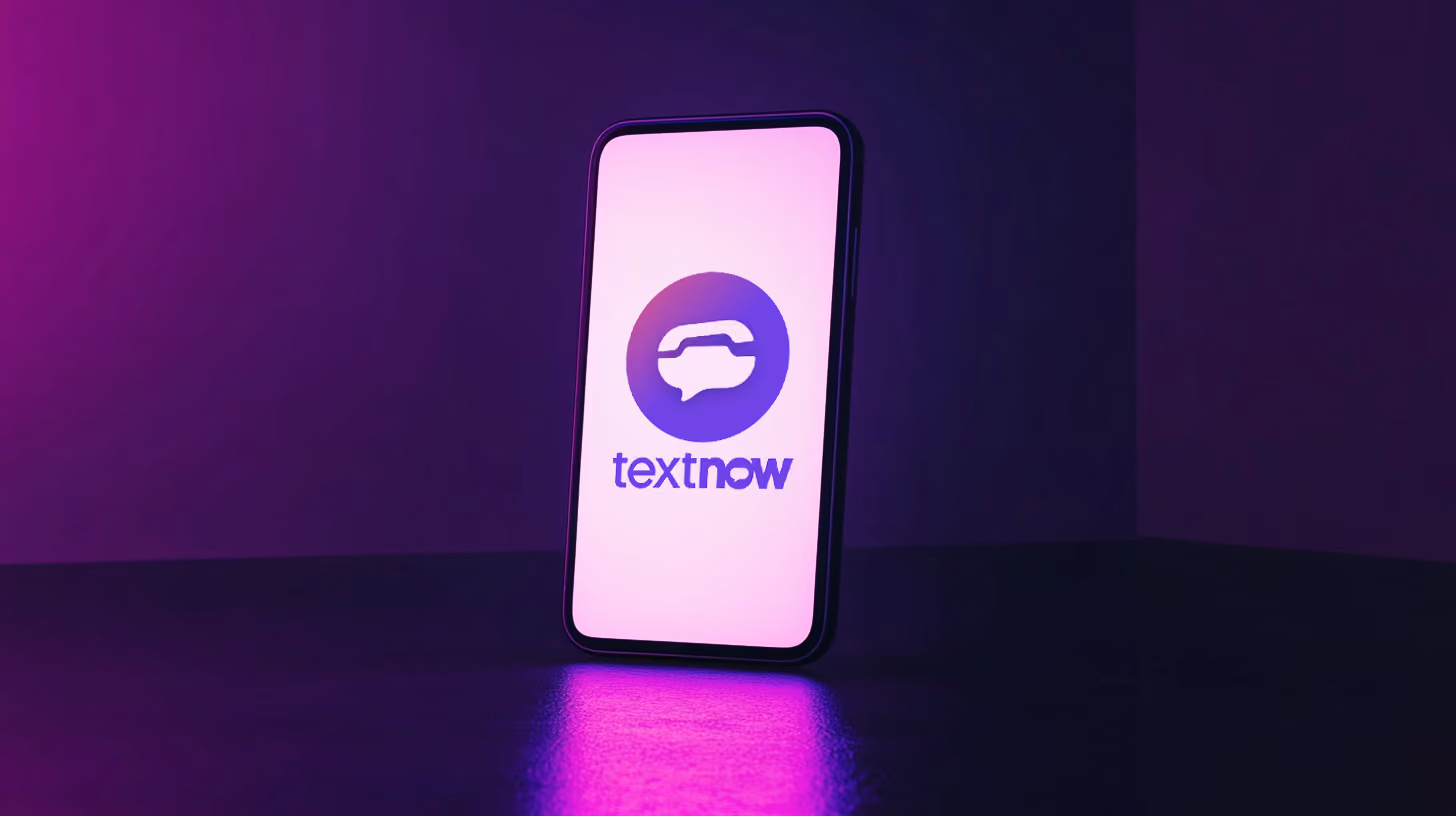 A phone standing with textnow logo on the screen