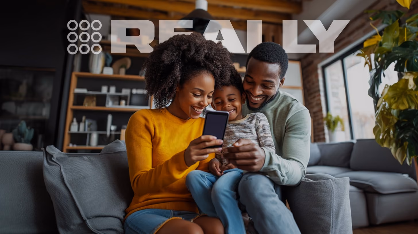 happy family watching on their phone, standing intheir family room, happy vibes